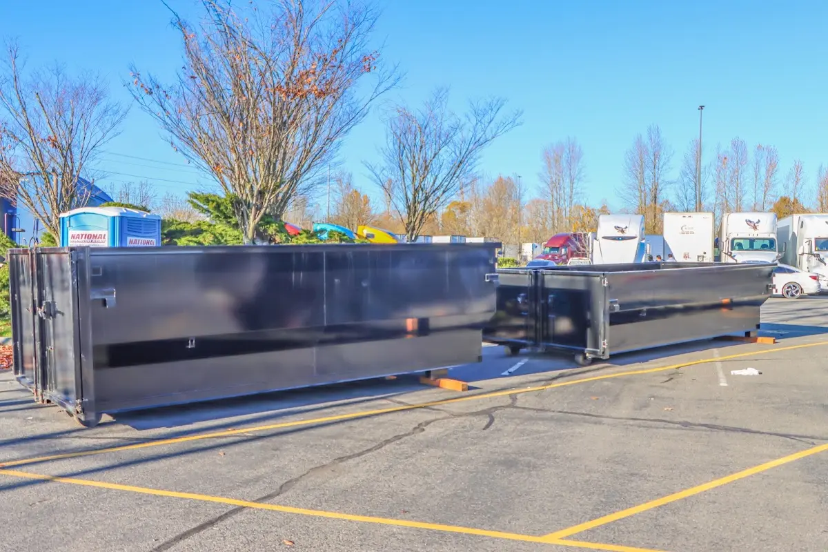 Professional dumpster rental service with roll-off container on residential driveway in Fargo